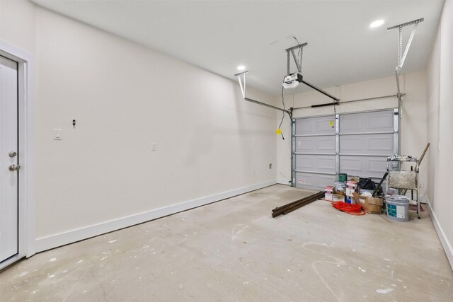 1310 E Alamo St A-B, Unit A-B Brenham, TX 77833 - garage featuring baseboards and a garage door opener