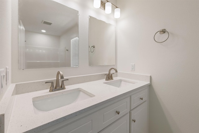 1310 E Alamo St A-B, Unit A-B Brenham, TX 77833 - full bath with a sink, visible vents, a shower, and double vanity