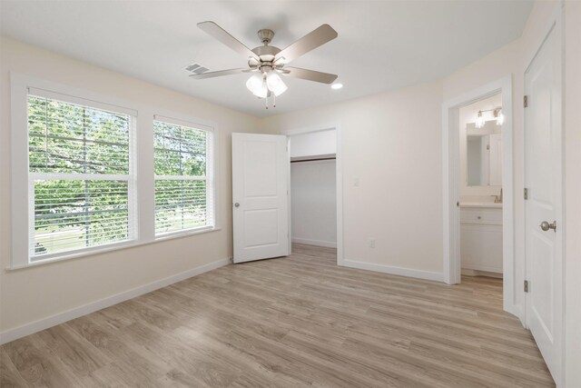 1310 E Alamo St A-B, Unit A-B Brenham, TX 77833 - unfurnished bedroom featuring visible vents, baseboards, light wood finished floors, and ensuite bathroom