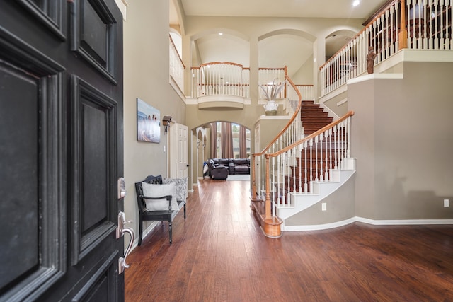 entryway featuring a towering ceiling, french doors, and dark hardwood / wood-style flooring