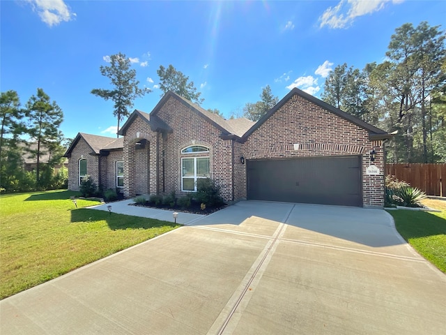 view of front of property with a garage and a front yard