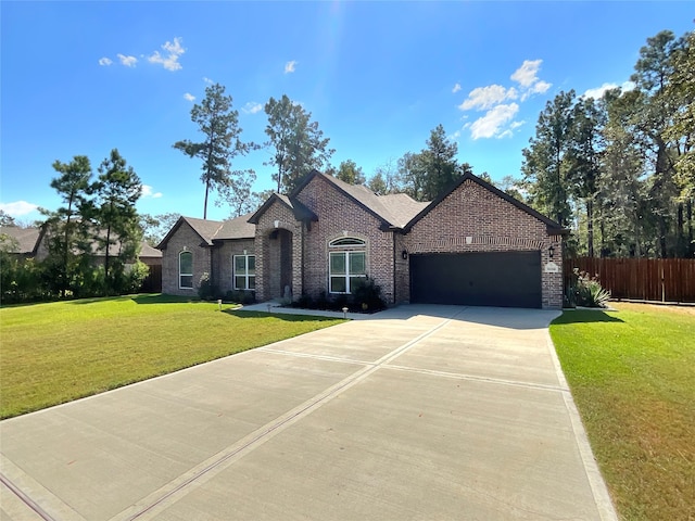 view of front of property featuring a garage and a front lawn