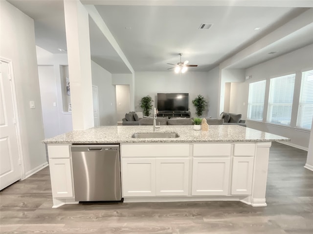 kitchen with light hardwood / wood-style floors, sink, light stone countertops, stainless steel dishwasher, and white cabinetry