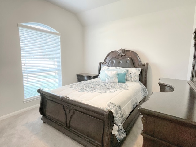 carpeted bedroom featuring vaulted ceiling