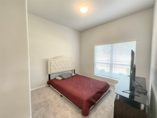 bedroom featuring light carpet