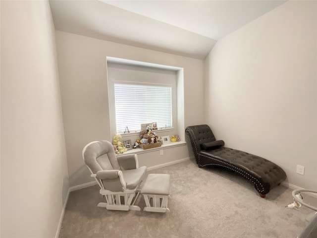 sitting room featuring lofted ceiling and light colored carpet