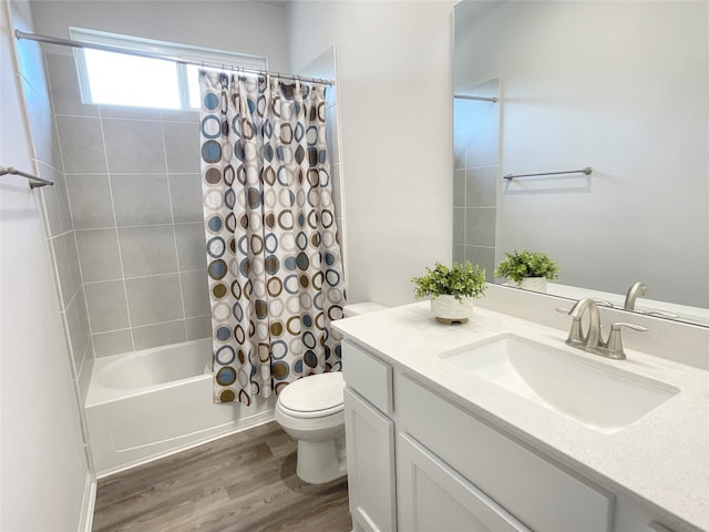 full bathroom with shower / bath combination with curtain, hardwood / wood-style floors, vanity, and toilet