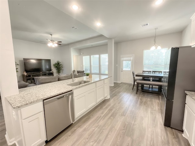 kitchen featuring white cabinets, appliances with stainless steel finishes, and sink