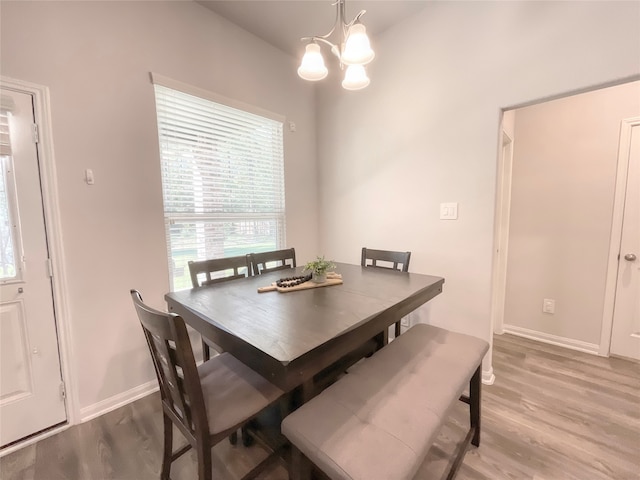 dining room featuring wood-type flooring and a notable chandelier