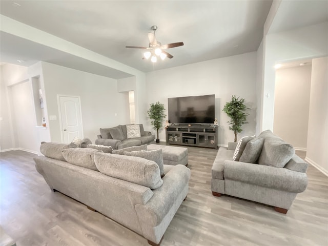 living room with light wood-type flooring and ceiling fan