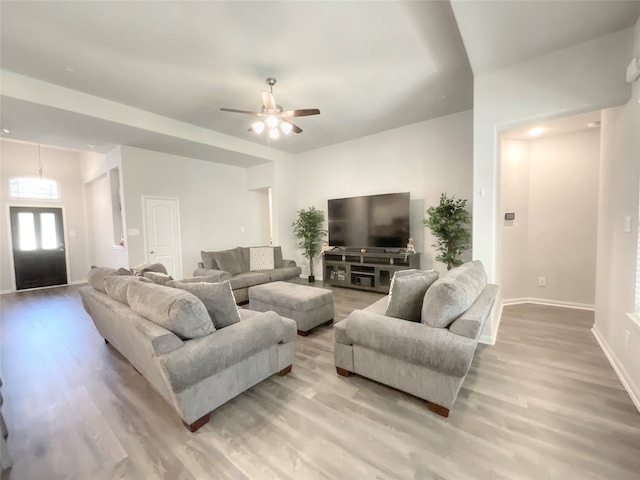 living room with light hardwood / wood-style floors and ceiling fan