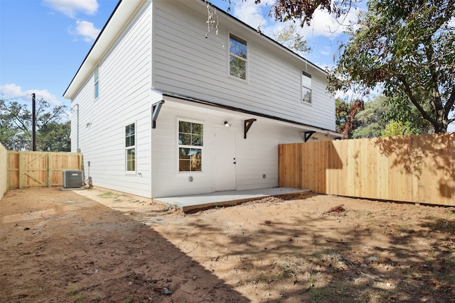 rear view of house featuring a patio area and central AC