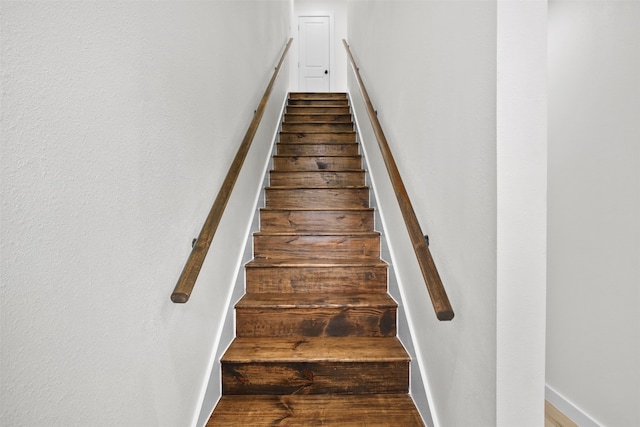 stairs featuring hardwood / wood-style floors