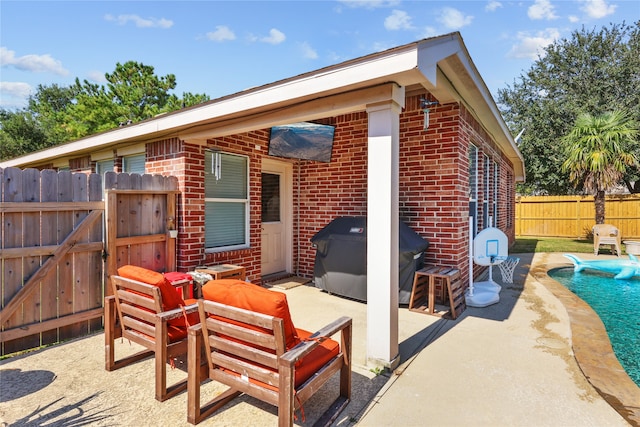 view of patio with a grill and a fenced in pool