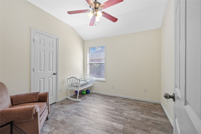 sitting room with light hardwood / wood-style flooring, vaulted ceiling, and ceiling fan