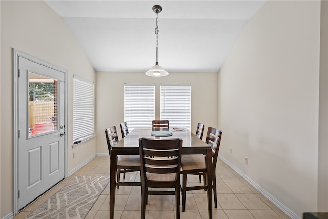 tiled dining area with vaulted ceiling