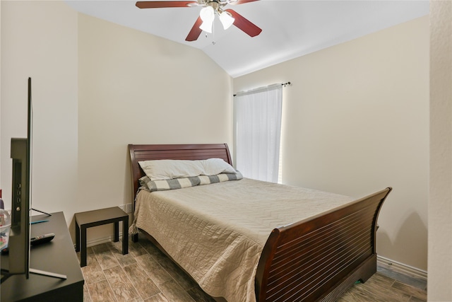 bedroom with ceiling fan, wood-type flooring, and vaulted ceiling