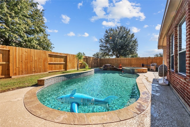 view of pool featuring a patio and an in ground hot tub