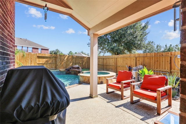 view of patio / terrace with a grill and a pool with hot tub