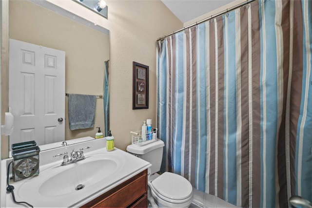 bathroom featuring toilet, curtained shower, and vanity