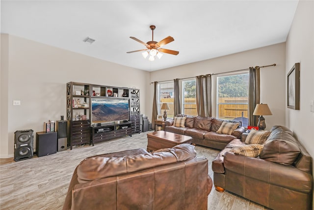 living room featuring ceiling fan and hardwood / wood-style flooring