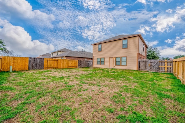 rear view of property featuring a lawn