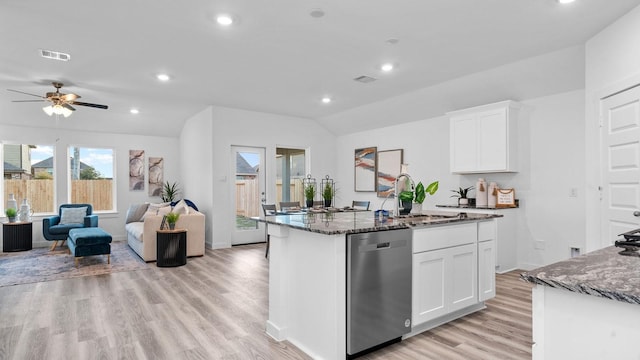 kitchen with sink, stainless steel dishwasher, dark stone counters, a center island with sink, and white cabinets