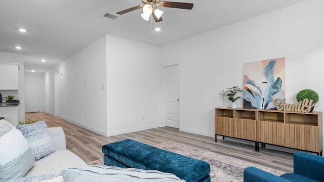 living room featuring ceiling fan and light hardwood / wood-style floors