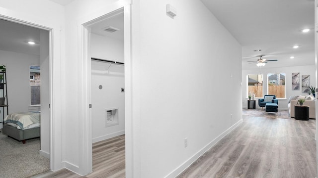 corridor featuring light hardwood / wood-style floors