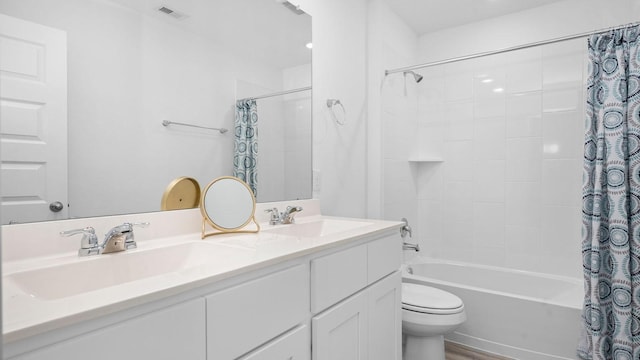 full bathroom featuring hardwood / wood-style floors, shower / bath combination with curtain, toilet, and vanity