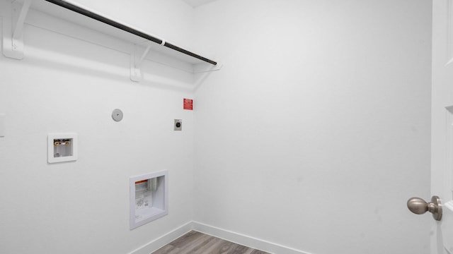 laundry area featuring hardwood / wood-style flooring, hookup for a gas dryer, hookup for an electric dryer, and washer hookup