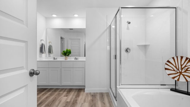 bathroom featuring separate shower and tub, vanity, and wood-type flooring