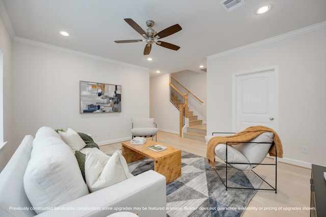 living room with light wood-type flooring, crown molding, and ceiling fan