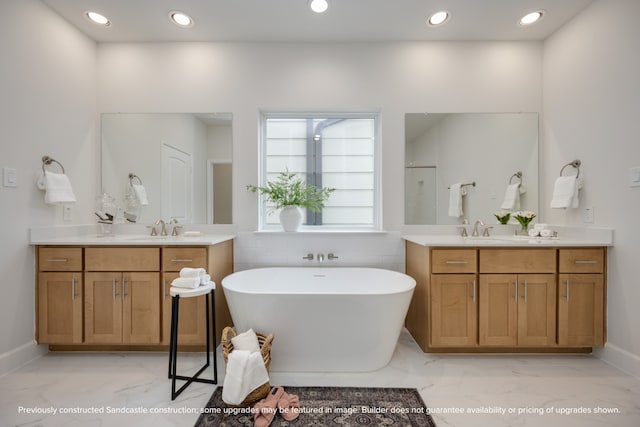 bathroom featuring a tub and vanity