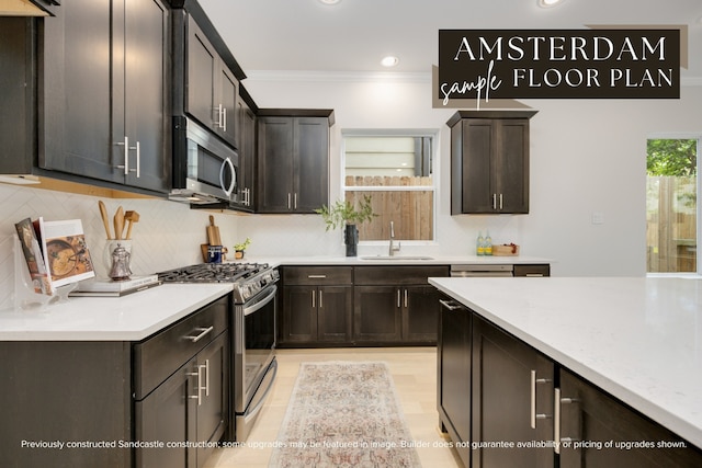 kitchen featuring decorative backsplash, stainless steel appliances, sink, ornamental molding, and dark brown cabinets