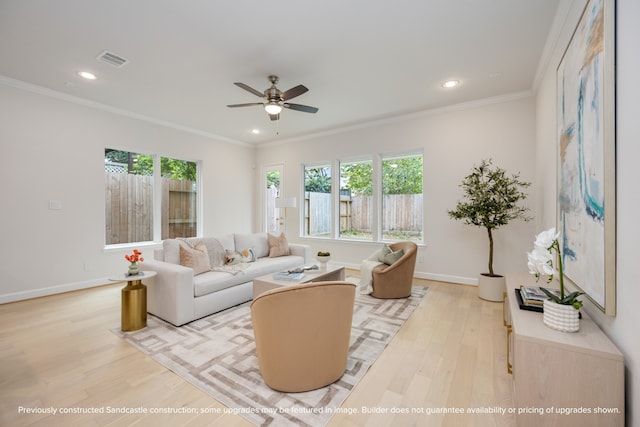 living room featuring light hardwood / wood-style floors, ornamental molding, and ceiling fan