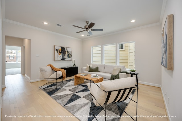 living room featuring crown molding, ceiling fan, and light hardwood / wood-style floors