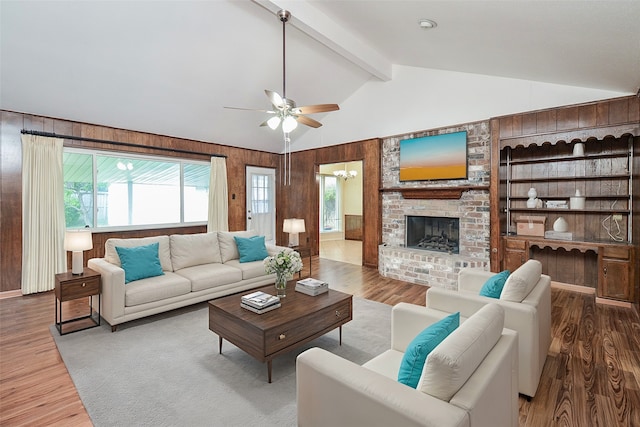 living room featuring vaulted ceiling with beams, hardwood / wood-style floors, and a healthy amount of sunlight