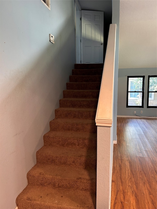 stairs with hardwood / wood-style floors