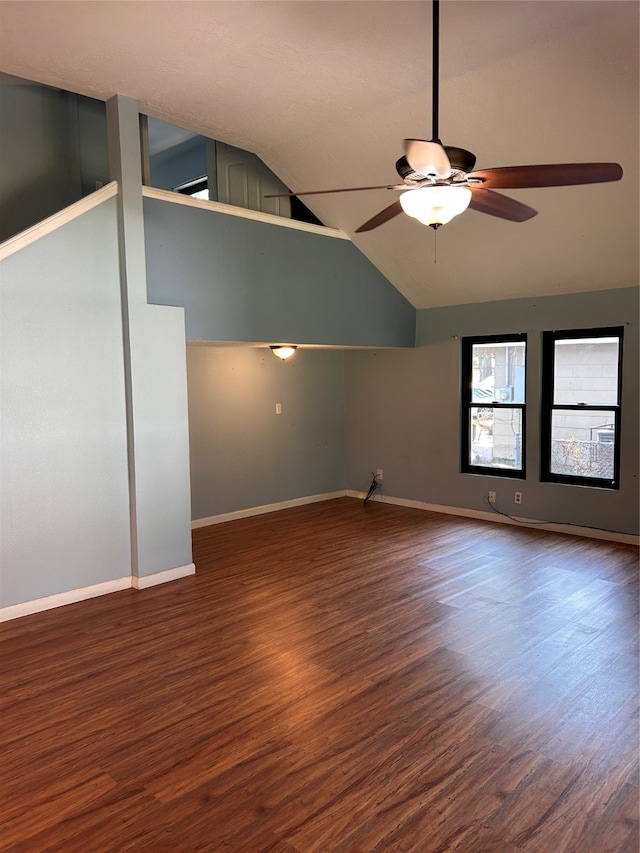 interior space featuring ceiling fan, dark wood-type flooring, and vaulted ceiling