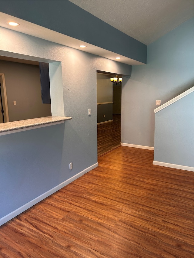 unfurnished room featuring hardwood / wood-style floors and a textured ceiling