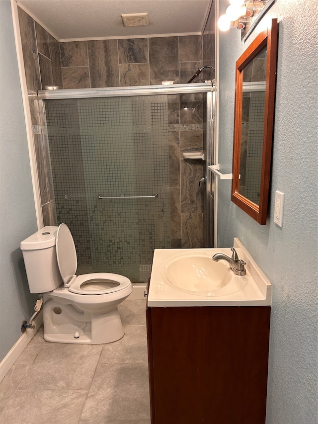 bathroom featuring vanity, a textured ceiling, a shower with shower door, tile patterned floors, and toilet