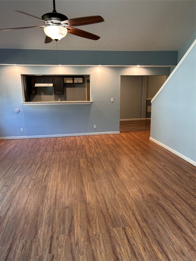 unfurnished living room with ceiling fan and dark hardwood / wood-style floors