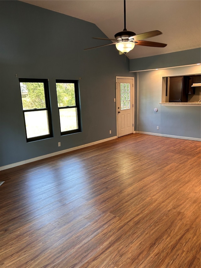 spare room featuring lofted ceiling, dark hardwood / wood-style floors, and ceiling fan