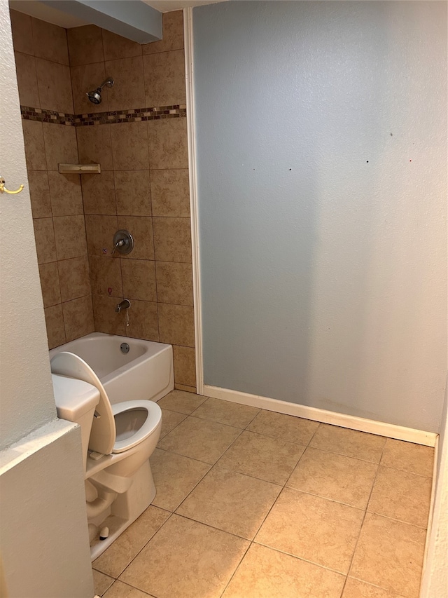 bathroom with tiled shower / bath, toilet, and tile patterned floors