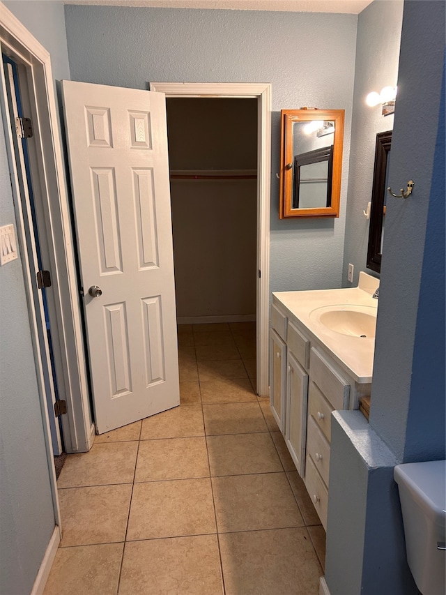 bathroom with tile patterned floors, vanity, and toilet