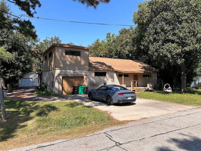 view of property with a garage and a front lawn