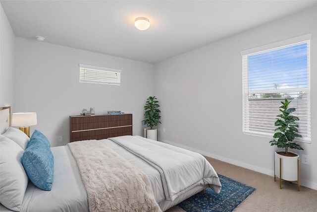 6702 Old Cypress Landing Ln, Humble, TX 77338 - carpeted bedroom featuring baseboards and multiple windows