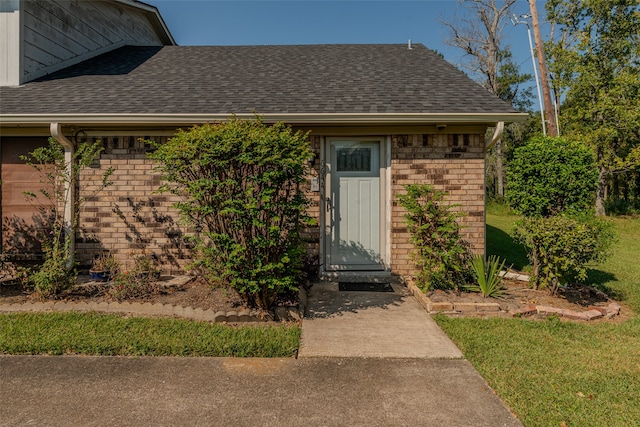 doorway to property featuring a lawn