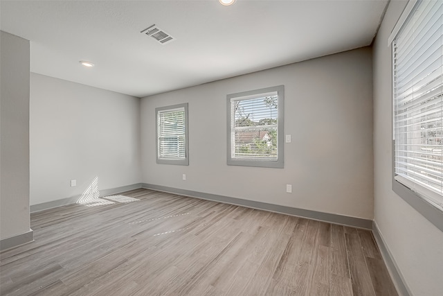 empty room with light hardwood / wood-style floors